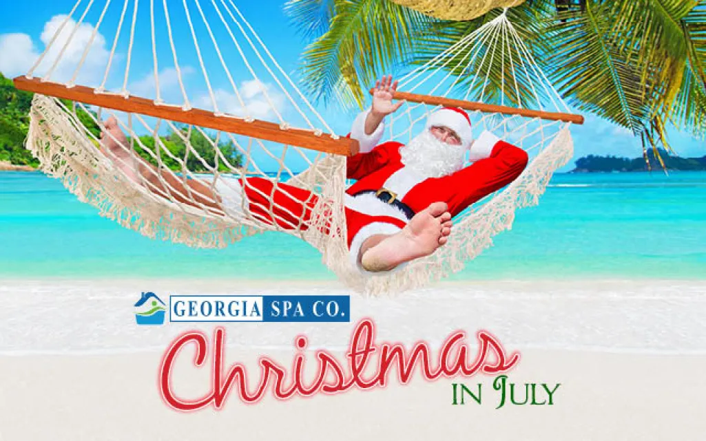 Santa Claus relaxing in a hammock on a tropical beach with palm trees and clear blue water for Christmas in July.