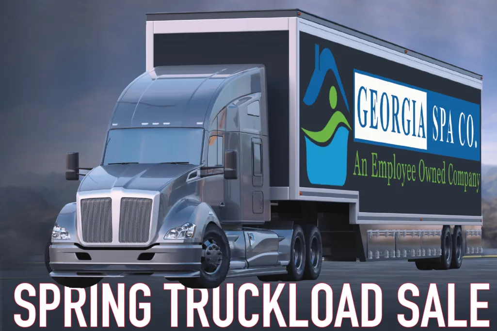 Silver semi truck with Georgia Spa Co. trailer parked at dusk promoting spring truckload sale