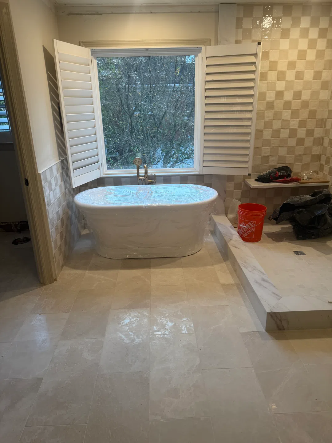 Custom tiled walk-in shower with glass enclosure