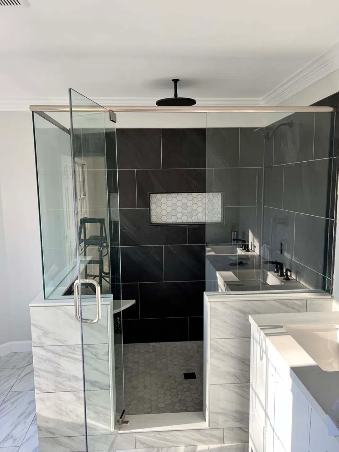 Completed bathroom remodel with tiled walls and floor
