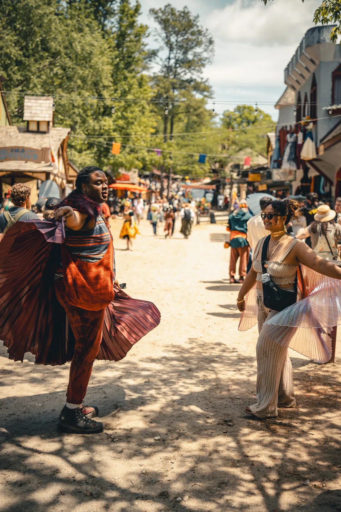 Dancers in flowing skirts performing in the streets of the Georgia Renaissance Festival village