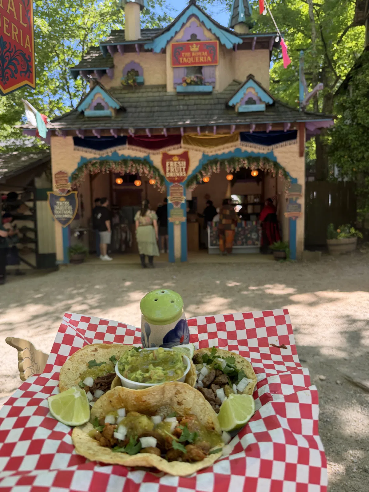 Three street tacos and a cup of guacamole in front of The Royal Taqueria in Olde Towne