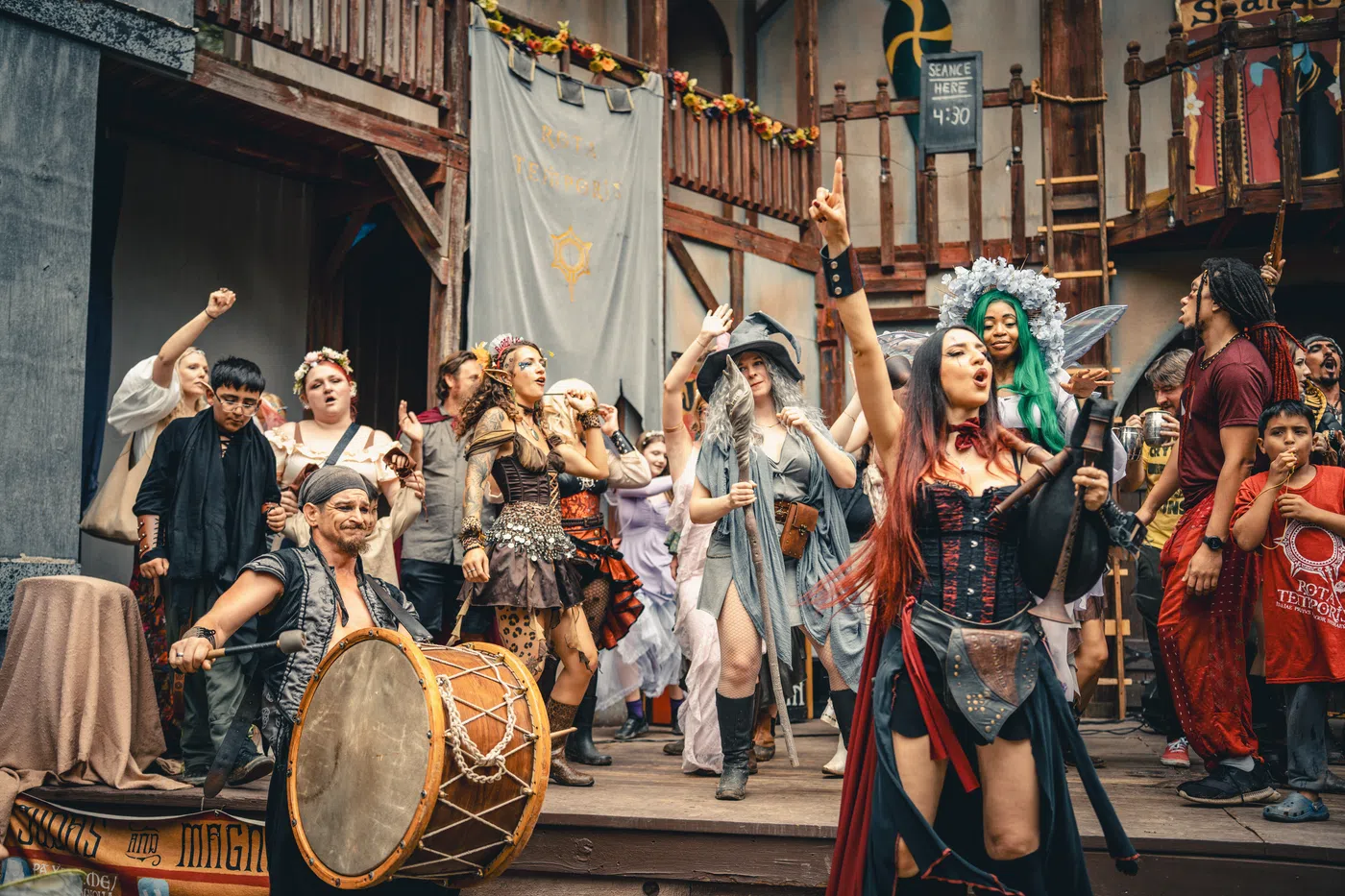 A wide view of a lively pirate-themed gathering in the Festival village.