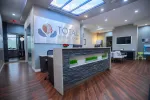 Modern dental office reception area with stone desk