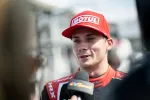 Race car driver in a red Motul cap giving a post-race interview with NBC Sports microphone.