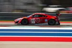 Red race car number 93 speeding on a track with blurred background and red, white, blue stripes in foreground