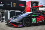 Black and red Lamborghini race car number 45 with DEX Imaging branding in a racing pit area.
