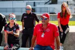 Group of Acura racing team members in branded uniforms and sunglasses during an outdoor event.