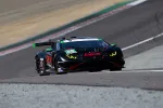 Black and red Lamborghini race car number 45 speeding on a racetrack with visible turn and elevated section.