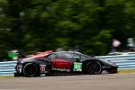 Black and red Lamborghini race car number 45 with DEX Imaging branding speeding on a racetrack.