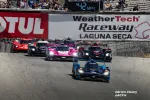 Prototype race cars leading a pack at WeatherTech Raceway Laguna Seca under a speed display showing 42 MPH.