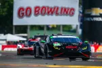 Black and red Lamborghini race car with number 45 on track under Go Bowling banner during race.