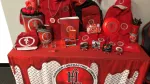 Various red promotional items with Harrison Contracting Company logo displayed on a branded red tablecloth.