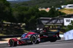 Red and black Acura prototype race car on a racetrack during a sunny day with trees in the background