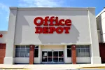 Storefront of an Office Depot location with red signage on white and brick exterior under a blue sky.