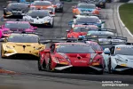 Lamborghini race cars competing closely on a racetrack during a high-speed motorsport event.