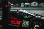 Black and red race car number 45 with WeatherTech decal at pit stop during a race event.