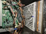 AC Repair and Maintenance in Alpharetta 30005 by The Air Company of GA. Inside view of HVAC unit showing circuit board, tangled wires, and air filter with warning label.