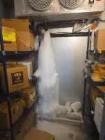 Atlanta Commercial Refrigeration Repair and Cleaning by The Air Company of GA.  Large ice formation from a leak inside a storage room with shelves and cardboard boxes.