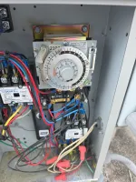 Atlanta Commercial Refrigeration Repair and Cleaning by The Air Company of GA. Close-up of an electrical control panel with a timer switch, wires, and relays inside a metal enclosure.