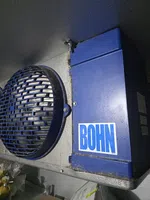 Commercial Walk-In Cooler Repair in Sandy Springs by The Air Company of GA. Close-up of a blue industrial cooling unit with a metal fan guard and BOHN logo on the side.