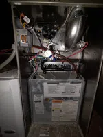 HVAC Real Estate Inspection in Atlanta by The Air Company of GA. Open HVAC furnace showing internal wiring, metal components, labels, and ventilation duct inside a utility space.