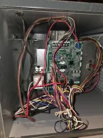 Furnace Heating Repair in Atlanta Sandy Springs 30350 by The Air Company of GA.  Open electrical panel showing complex wiring connected to a green circuit board inside a metal enclosure.