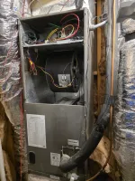 Residential AC Furnace Repair in Marietta 30068 by The Air Company of GA.  Open HVAC unit with exposed wiring and insulated ducts in a residential utility space with insulation.
