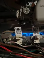Furnace Heating Repair in Alpharetta 30009 by The Air Company of GA.  Close-up of a gas furnace burner with blue flame and electrical wiring connections.