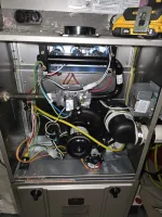 AC Cooling Repair in Atlanta 30318 by The Air Company. Interior view of a gas furnace showing wiring, burner assembly, blower motor, and gas valve components.