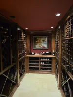 Wine Cellar Repair in Marietta 30068 by The Air Company of GA.  Wine cellar with wooden racks filled with wine bottles and a framed painting on the back wall.