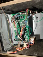 AC Repair and Maintenance in Alpharetta 30005 by The Air Company of GA. Open electronic control panel of HVAC system showing circuit board and colorful wiring inside metal housing.