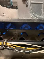 Heating Furnace Repair in Brookhaven Atlanta 30319 by The Air Company of GA.  HVAC furnace internals showing burner tubes, wiring, and metal components with blue flame visible.