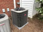 AC Cooling Dehumidification System Installation in Atlanta 30307 by The Air Company of GA.  Two outdoor air conditioning units installed beside a brick and wood house exterior on mulch ground.