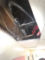 Commercial HVAC Repair in Atlanta 30306 by The Air Company of GA.  Exposed ceiling with ductwork, electrical wiring, wooden beams, and a red Milwaukee tool case in an unfinished space.