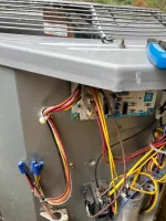 AC Repair and Maintenance in Smyrna 30080 by The Air Company of GA. Open electrical panel with wires, circuit board, and capacitor inside an HVAC unit outdoors.