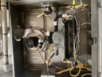 Heating Furnace Repair in Brookhaven Atlanta 30319 by The Air Company of GA.  Open residential furnace showing internal blower, burner assembly, wiring, and hot gas pipes.