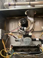 Heating Furnace Repair in Brookhaven Atlanta 30319 by The Air Company of GA.  Open residential furnace showing internal blower, burner assembly, wiring, and hot gas pipes.