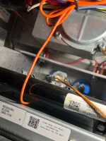 Residential HVAC AC Heating Repair Atlanta Brookhaven 30319 by The Air Company of GA.  Close-up of furnace control board with orange wires, metal components, and QR code labels inside HVAC unit.