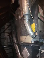 Furnace Heating Repair in Sandy Springs Atlanta 30328 by The Air Company of GA.  HVAC system with ductwork and furnace installed in a dimly lit attic space with tools nearby