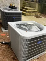 HVAC Repair in Sandy Springs 30328 by The Air Company of GA.  Two outdoor Carrier air conditioning units installed on a bed of pine straw near stone steps and a concrete walkway.