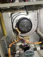 Residential Heating Furnace Repair in Norcross Atlanta 30071 by The Air Company of GA.  Inside view of a furnace showing blower motor, wiring, and gas valve components in metal casing