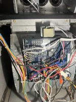 Furnace Heating Repair in Atlanta Decatur 30030 by The Air Company of GA.  Open electrical panel with a blue circuit board and numerous multicolored wires connected inside a metal enclosure.