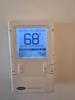 HVAC Thermostat Repair in Atlanta 30327 by The Air Company.  Carrier Infinity System thermostat showing 68 degrees inside temperature with heat mode and fan on high.