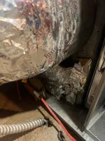 Furnace Heating Repair in Atlanta Decatur 30030 by The Air Company of GA.  Insulated flexible duct and metal furnace components with red and black electrical wires on concrete floor.