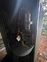 hvac-system-repair-and-capacitor-replacement-atlanta-30307-the-air-company-of-ga Interior view of an outdoor HVAC unit showing capacitor, wiring, and circuitry components with protective casing removed.