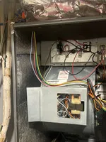 Sandy Springs Residential AC Repair by The Air Company of GA. Open HVAC system showing electrical wiring, motor, and insulated ductwork inside the metal casing.