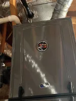 Residential HVAC AC Heating Repair Atlanta Brookhaven 30319 by The Air Company of GA.  RUUD HVAC furnace unit installed in attic space with wooden beams and ductwork visible