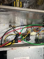 AC Repair and Maintenance in Smyrna 30080 by The Air Company of GA. Open metal panel showing colorful electrical wires connected inside an HVAC or electrical unit.