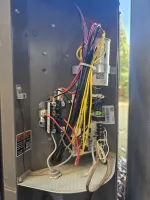 Residential HVAC Repair in Dunwoody 30338 by The Air Company of GA. Pressures are low on unit.  Open electrical panel showing organized wiring with red, yellow, black, and white cables connected to relays and circuit components.